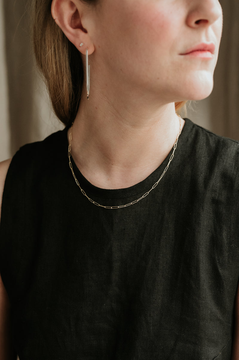 woman wearing hoops and stud earrings