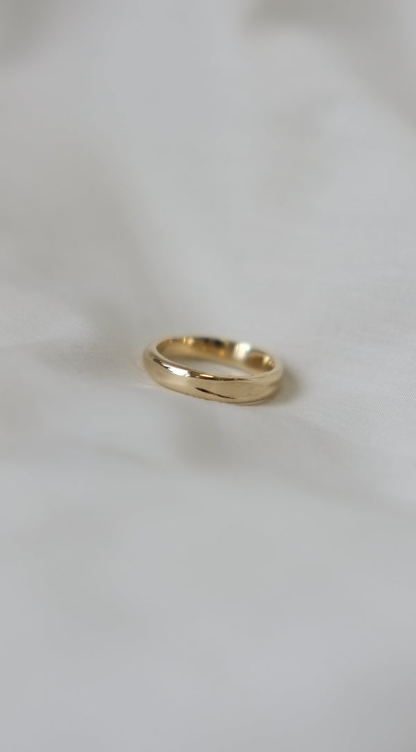 organis textured handmade gold ring on a white background