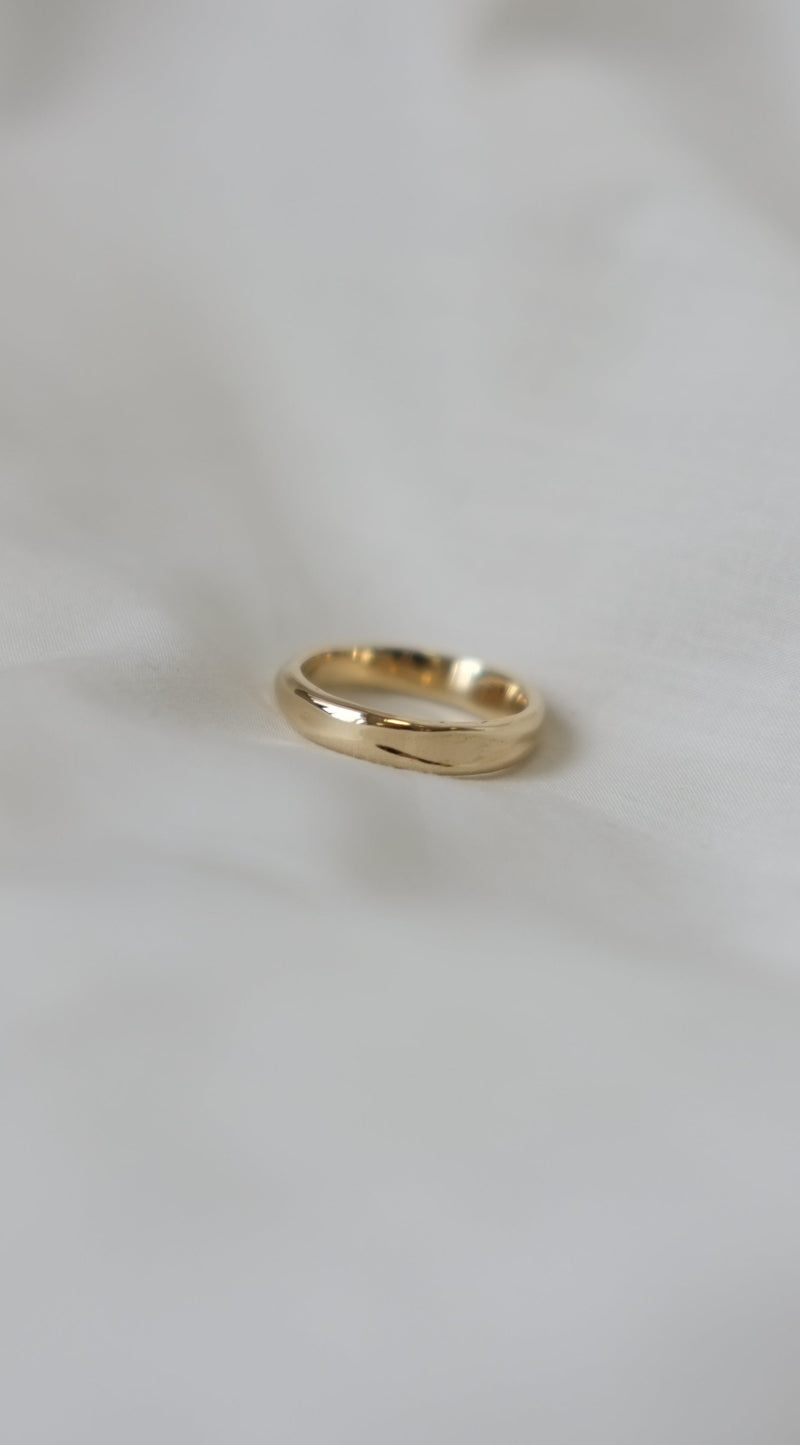 organis textured handmade gold ring on a white background