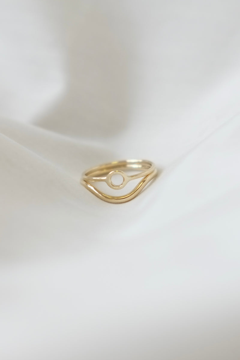 Minimal gold wedding band stacked with engagement ring, delicate handmade design