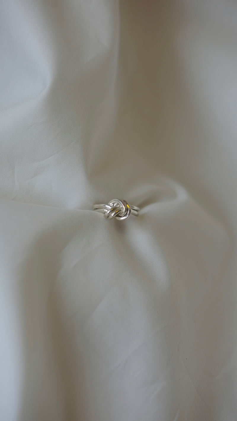 Double Knot Ring made from recycled silver on a white background - Studio Adorn Jewellery Norwich