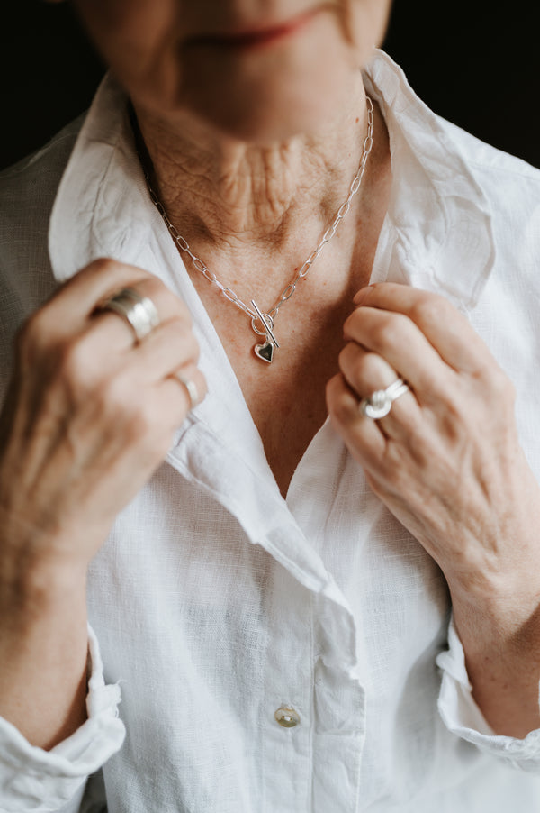 mature lady wearing studio adorn heart link and bar necklace