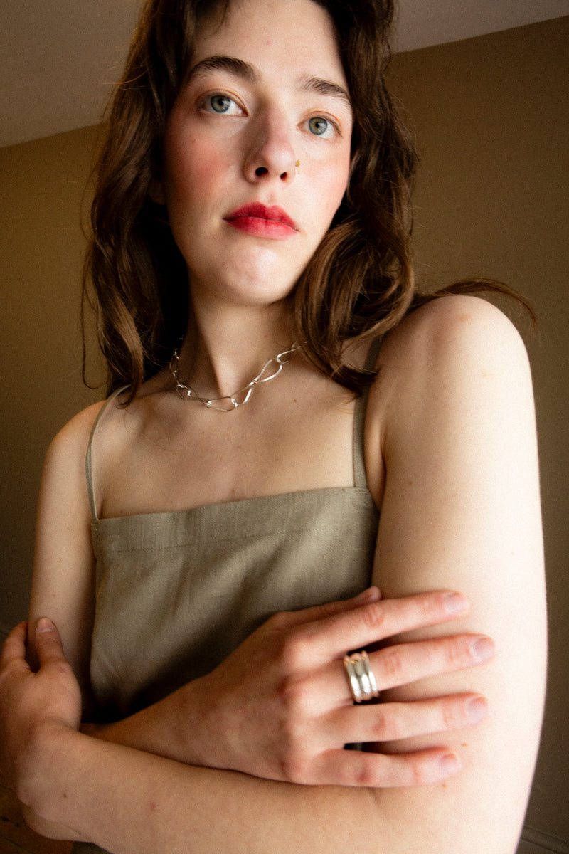 Model wearing bold Sterling Silver statement ring with soft, sculptural design