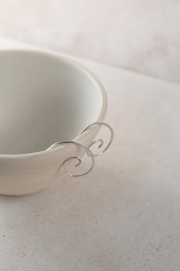 spiral hoops perched on a white bowl