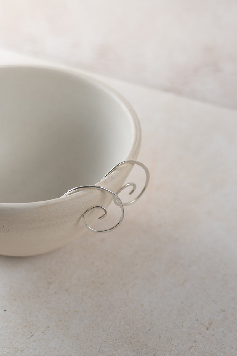 spiral hoops perched on a white bowl