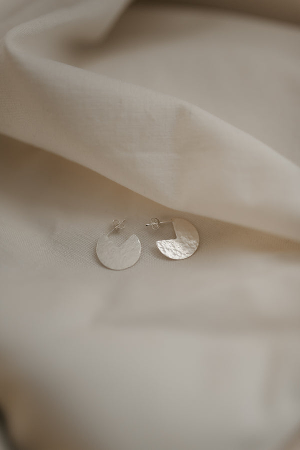 Circle cut out silver hammered disc earrings handmade by Studio Adorn