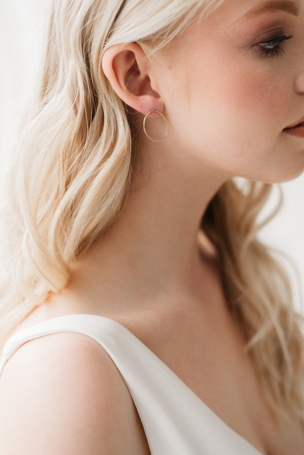 Studio Adorn side profile of model wearing handmade recycled gold organic free-formed studs
