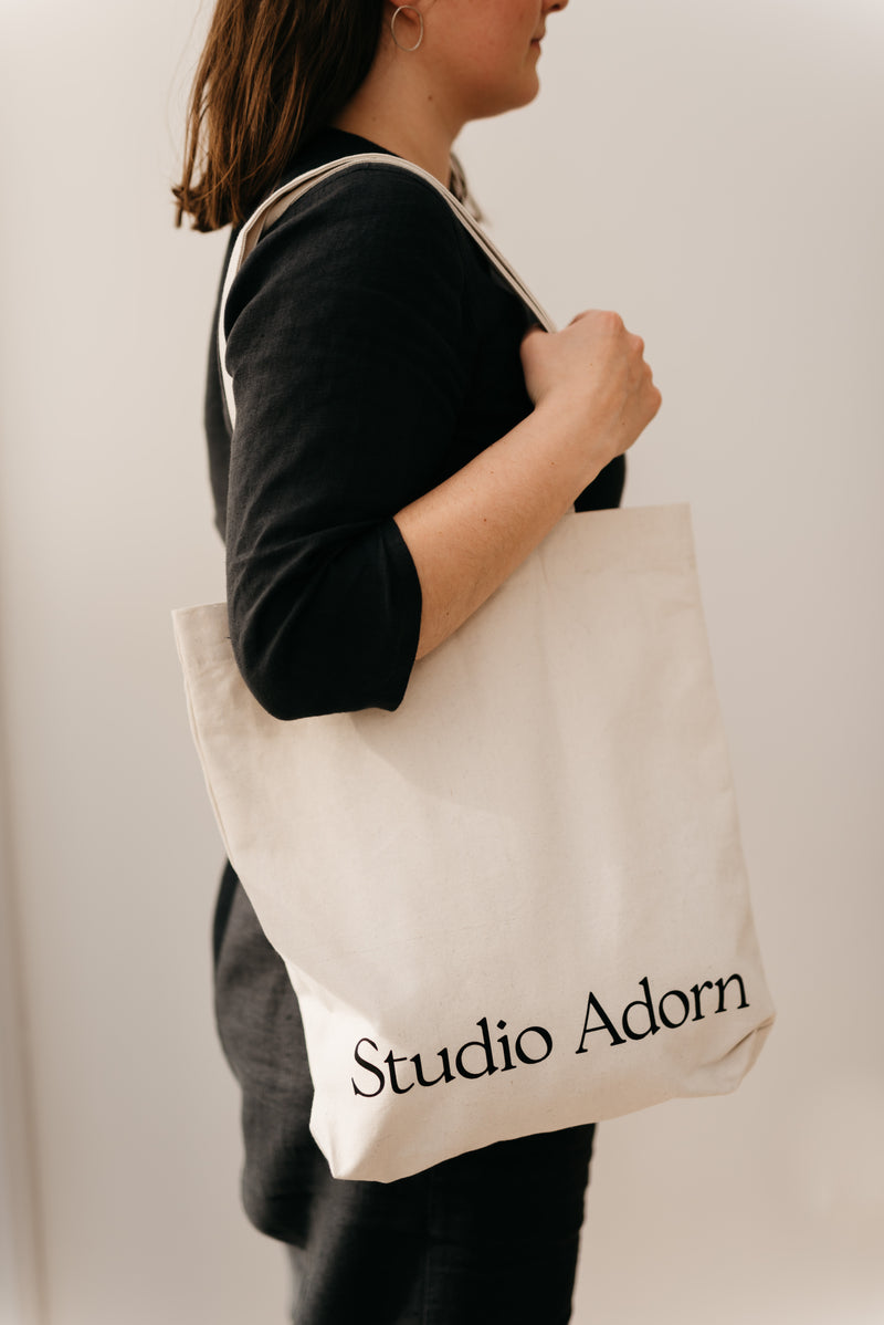 Model wearing Independent jeweller Studio Adorn's branded tote bag