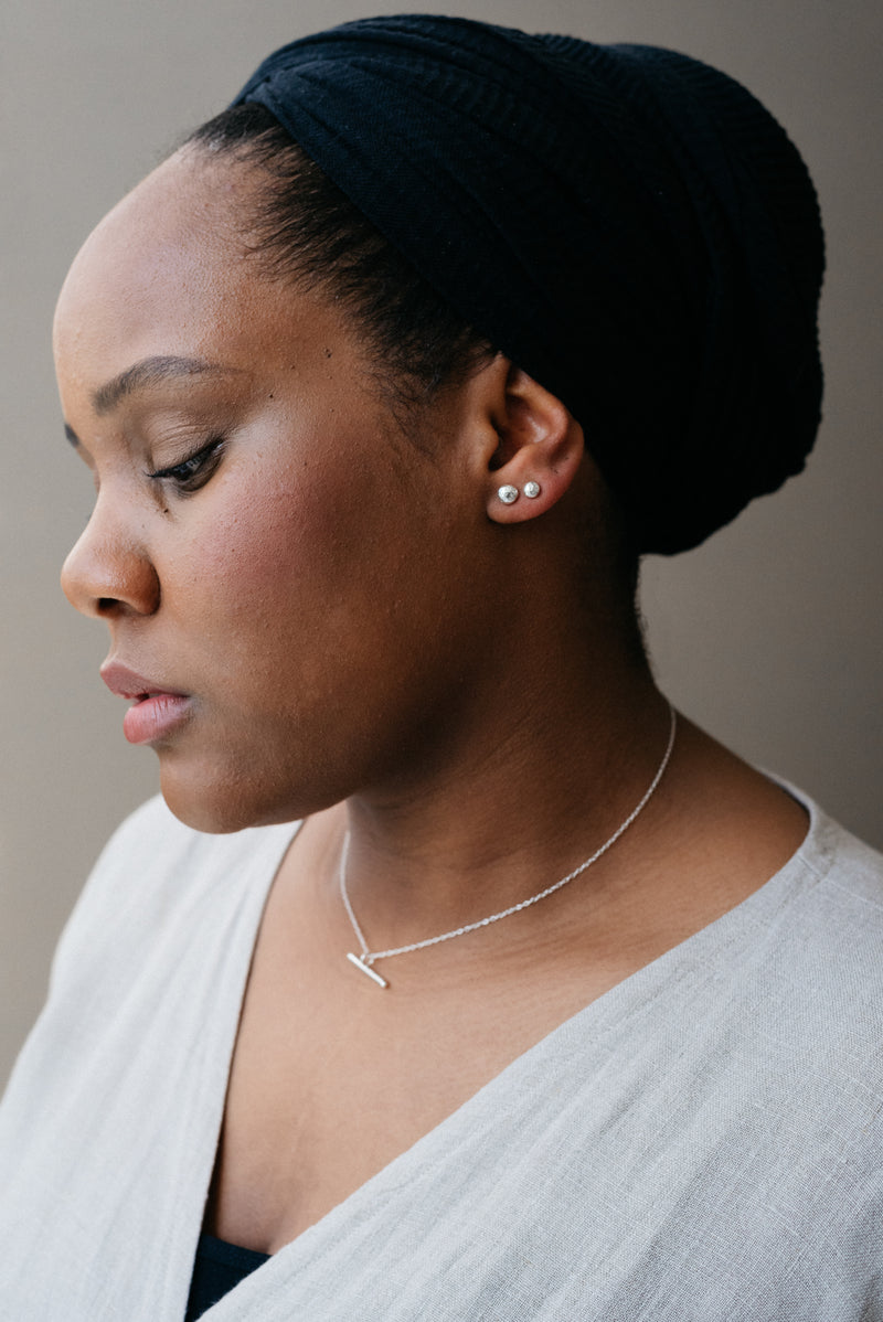 Model wearing Sustainable, ethical silver earrings handmade by Studio Adorn