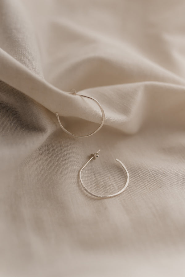 Silver free-formed open silver hoop earrings handmade by Studio Adorn