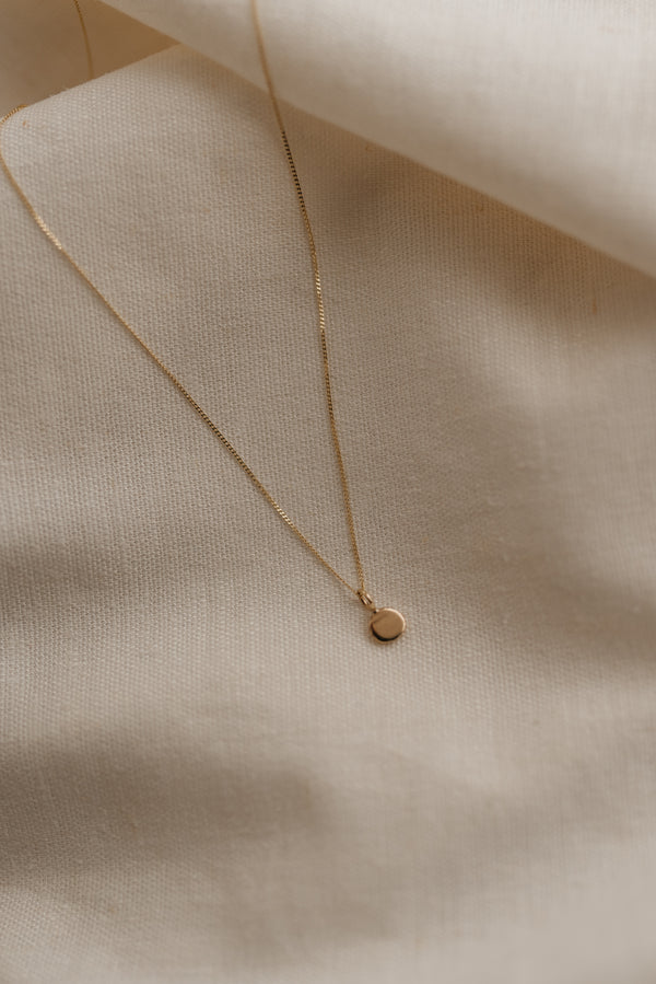 Studio Adorn handmade 9ct recycled gold zero waste pebble necklace on a fine curb chain 