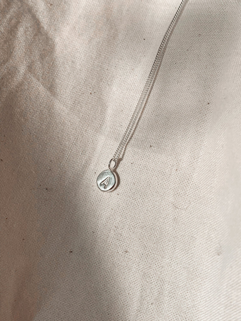 Studio Adorn sterling eco recycled silver zero waste pebble necklace with uppercase initial stamp | Handmade personalised gold jewellery