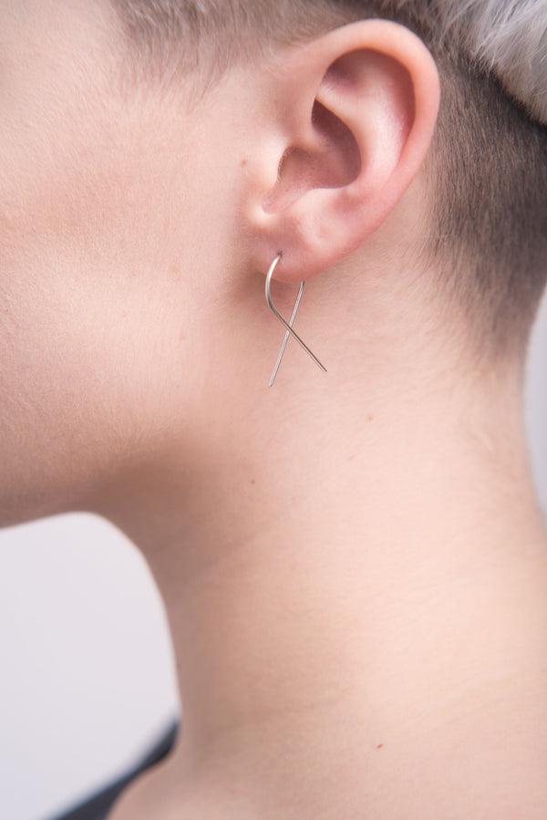 Model wearing twist silver ear pins handmade by Studio Adorn