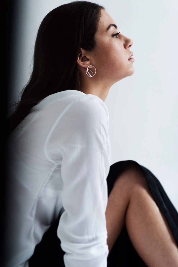 Model wearing statement silver hoop earrings handmade by Studio Adorn