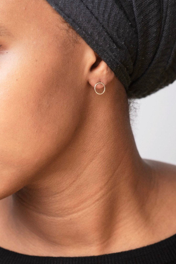 Studio Adorn side profile of model wearing minimalist recycled gold circle studs