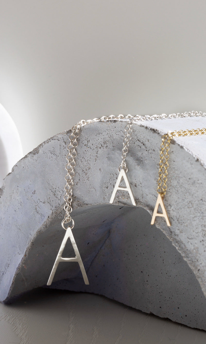 Studio Adorn recycled gold and silver uppercase initial pendent necklaces in mini, small and medium sizing