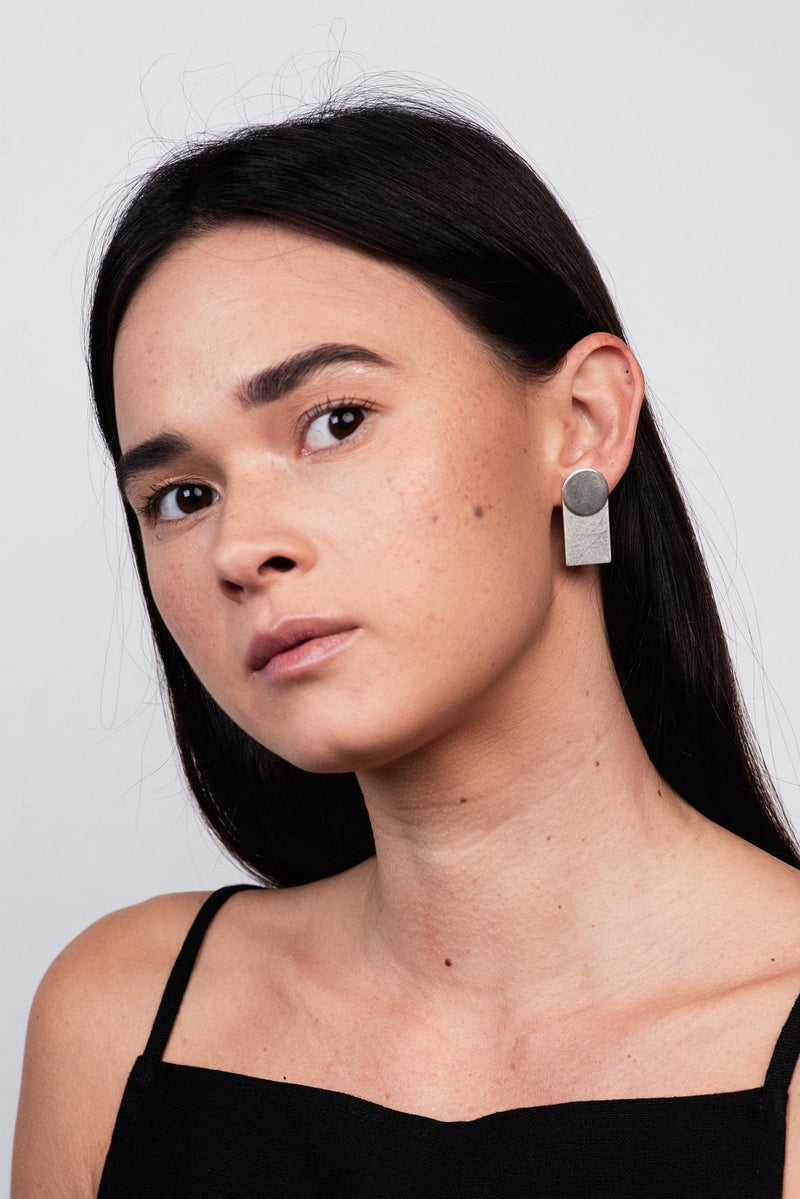 Model wearing statement silver shape ear jackets handmade by Studio Adorn