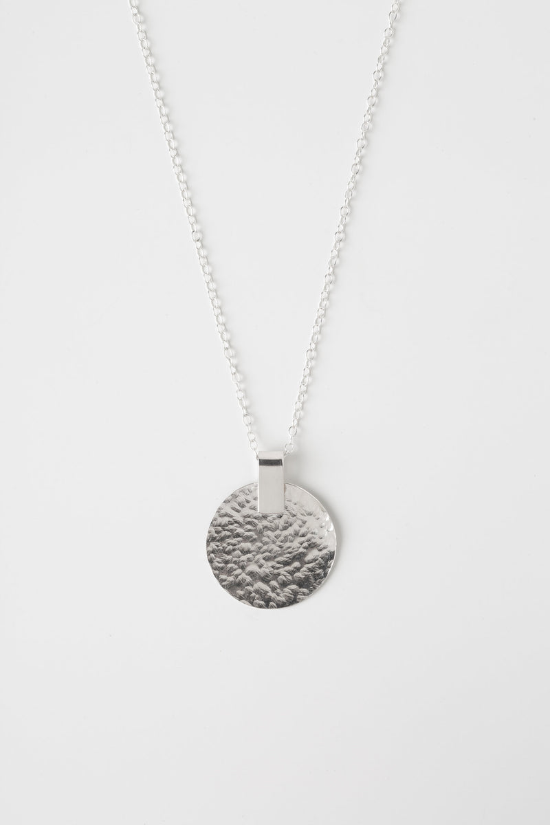 Hammered Silver disc necklace handmade by Studio Adorn