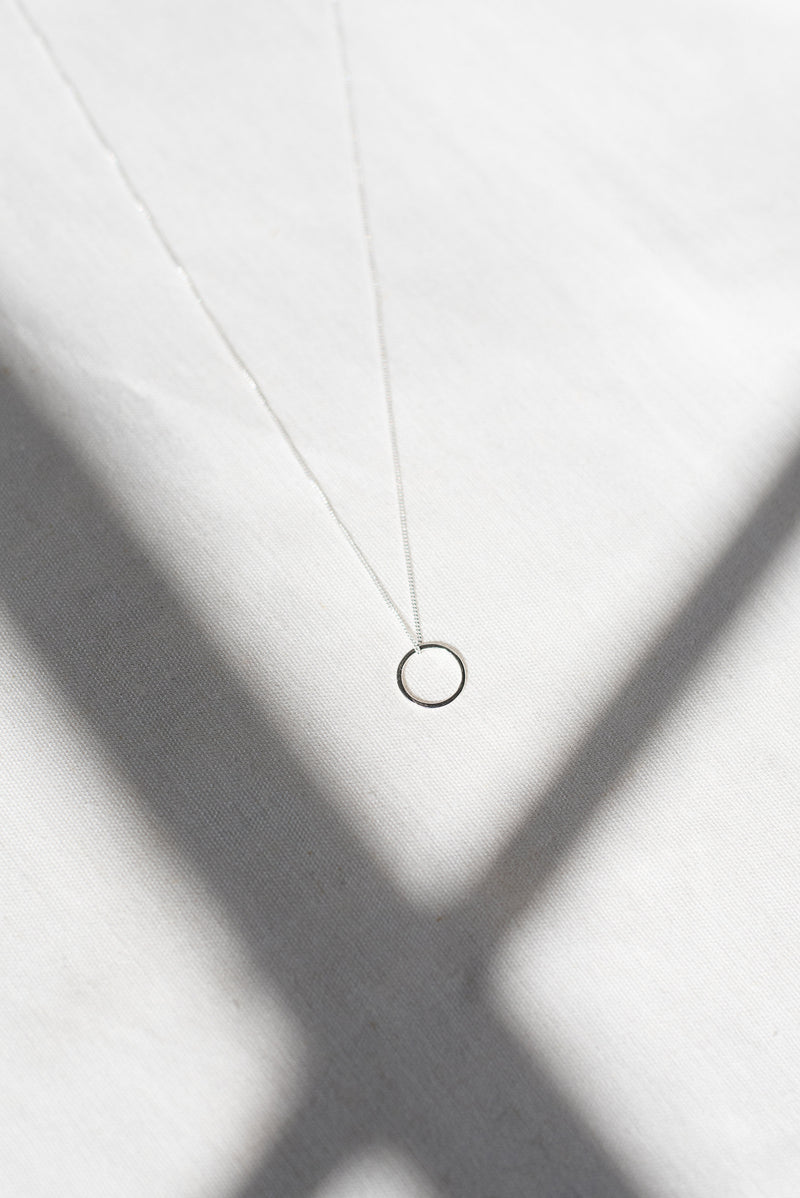 Mini circle silver pendant necklace handmade by Studio Adorn