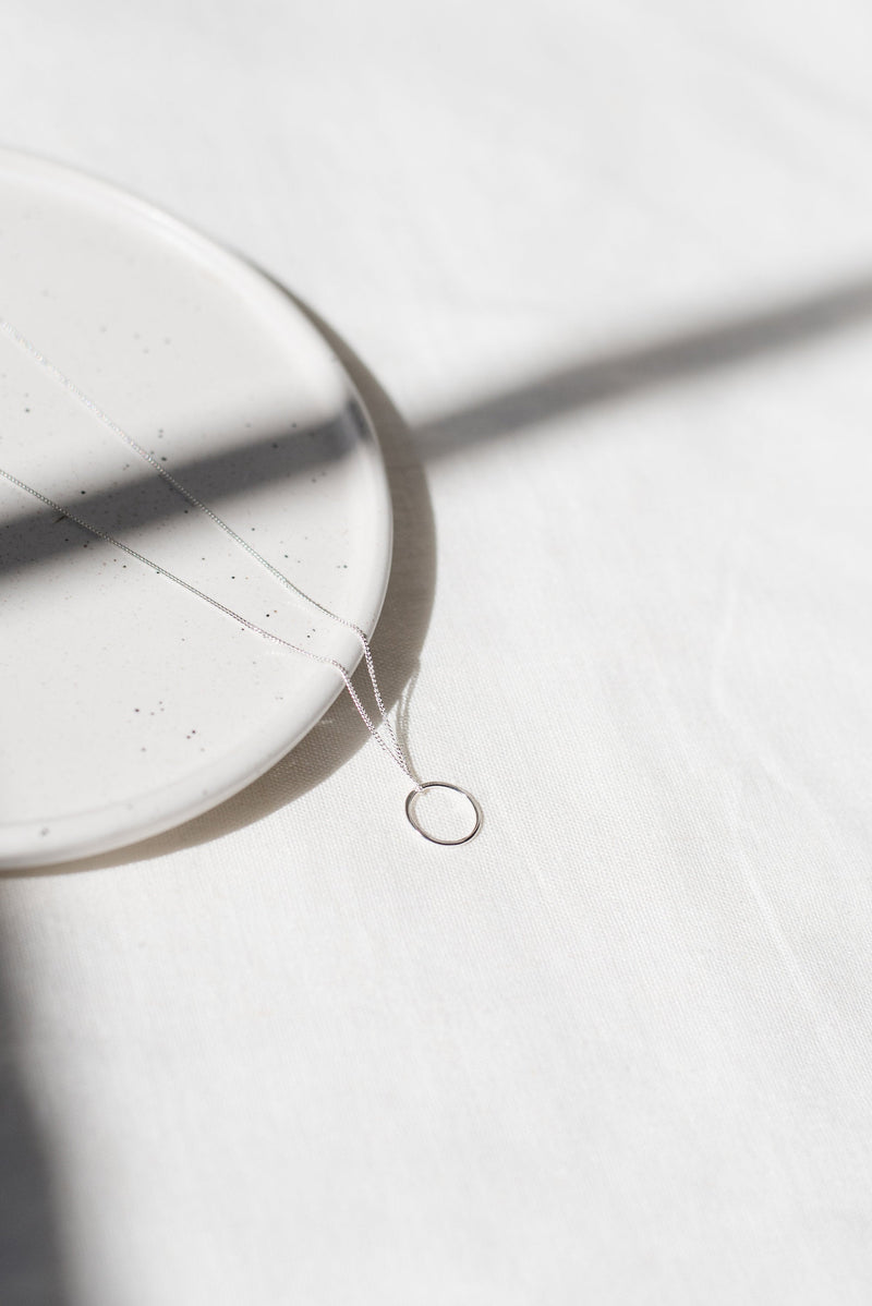 Mini circle silver pendant necklace handmade by Studio Adorn