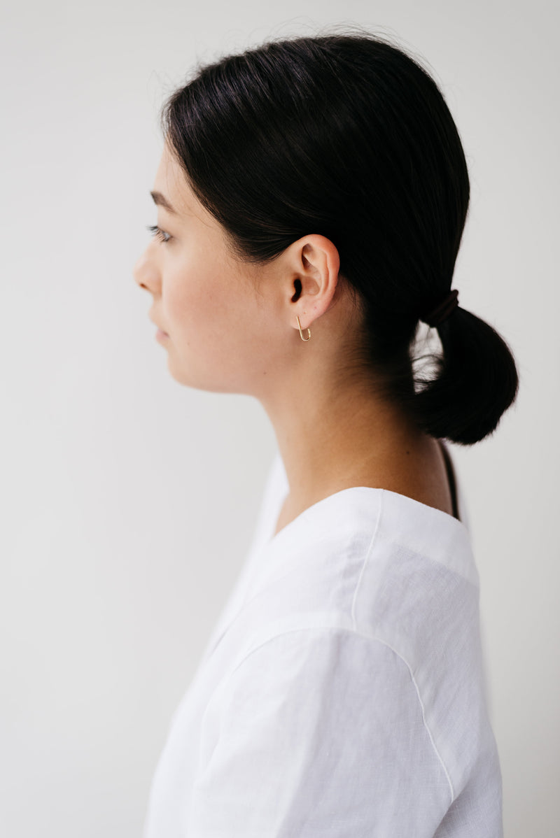 Studio Adorn side profile of model wearing 9ct gold curl stud earrings 