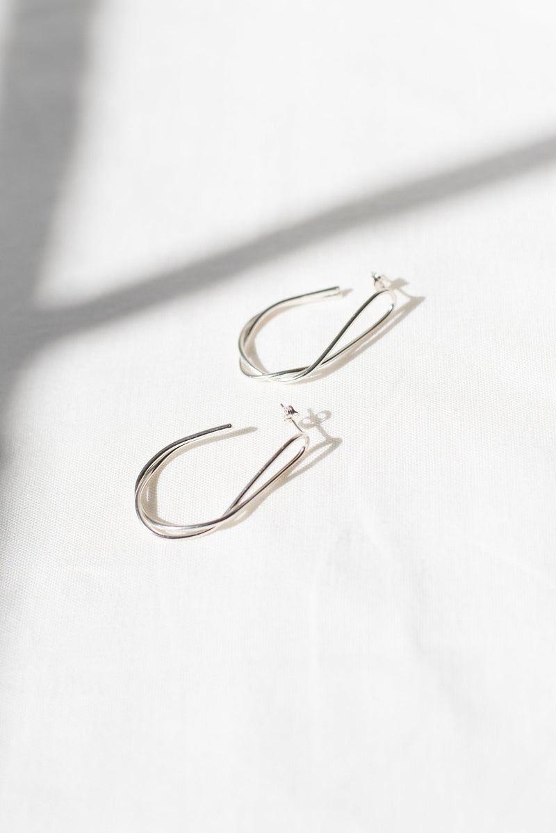 Statement silver twist hoop earrings handmade by Studio Adorn
