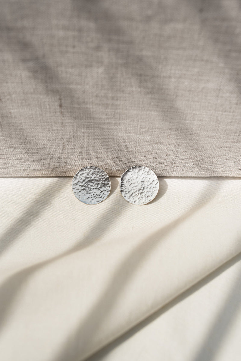 Silver hammered disc statement stud earrings handmade by Studio Adorn