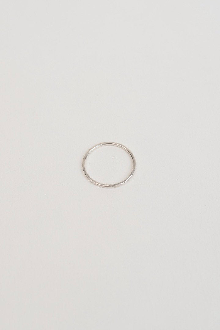 Model wearing plain hammered stacking ring in silver handcrafted by Studio Adorn