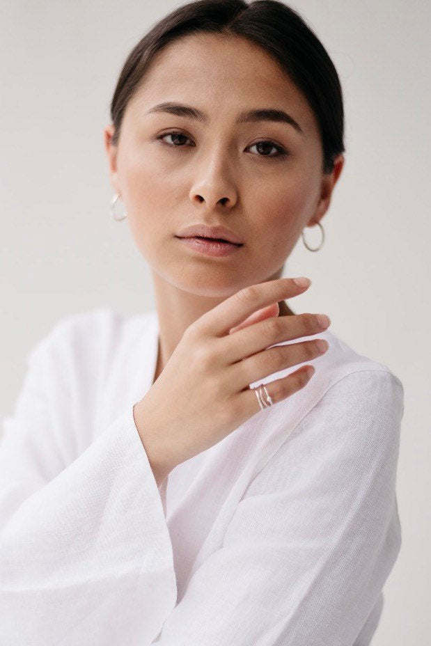 Portrait of model wearing Wave silver stacking ring handmade by Studio Adorn