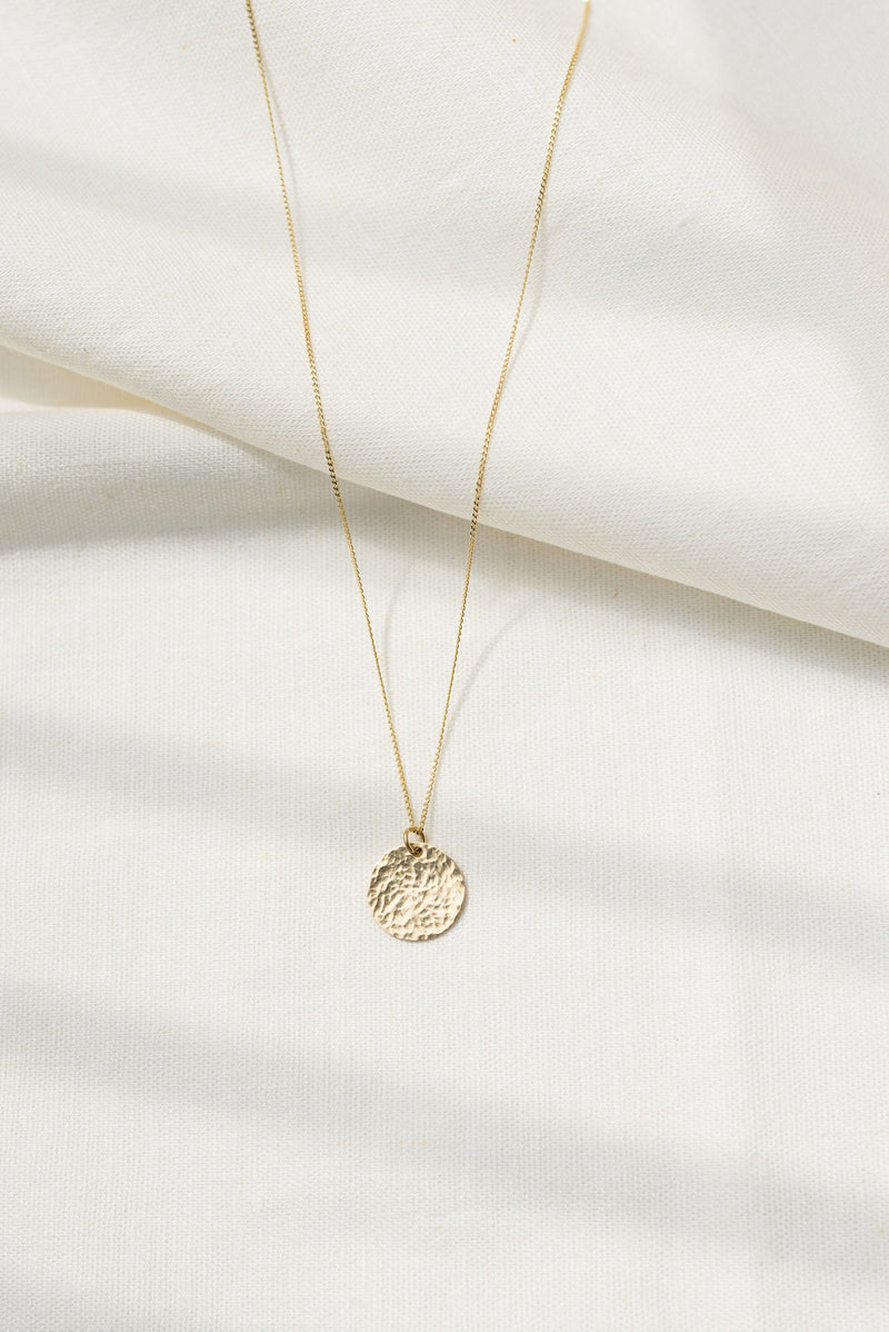 Studio Adorn handmade delicate gold hammered round disc necklace on gold diamond cut curb chain