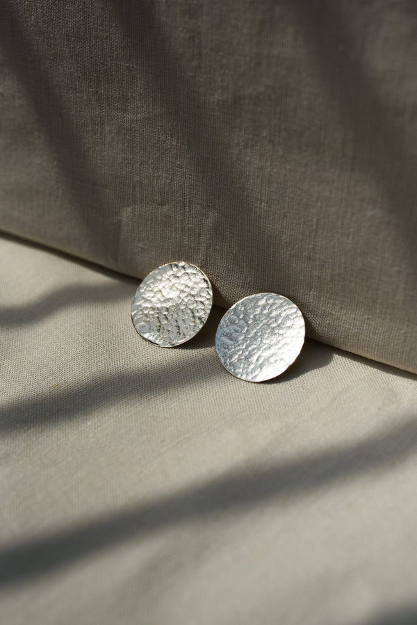 Silver hammered disc statement stud earrings handmade by Studio Adorn