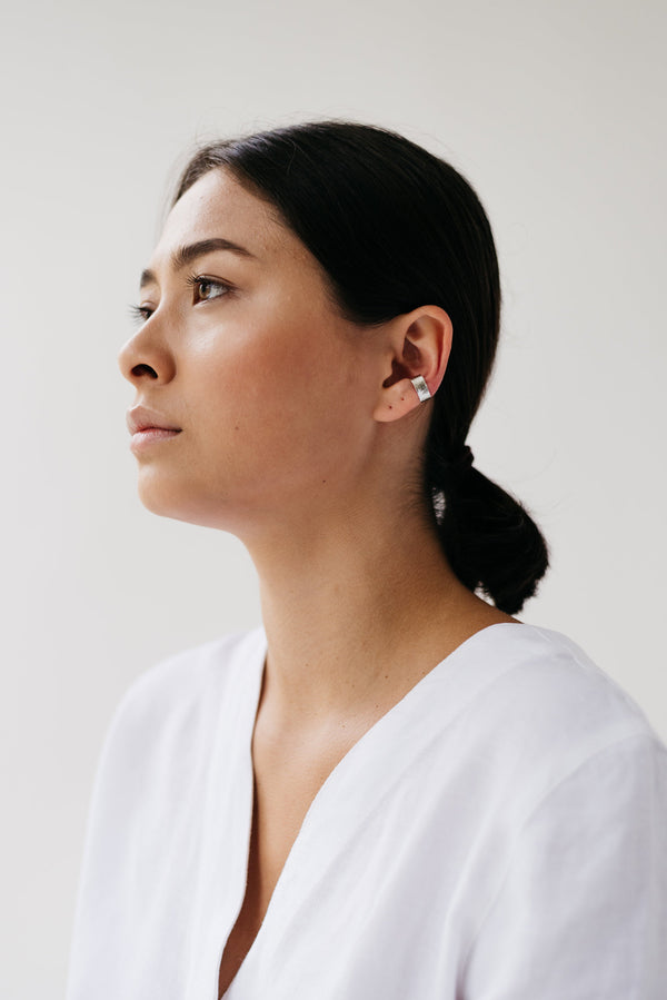 Model wearing silver ear cuff earring handmade by Studio Adorn