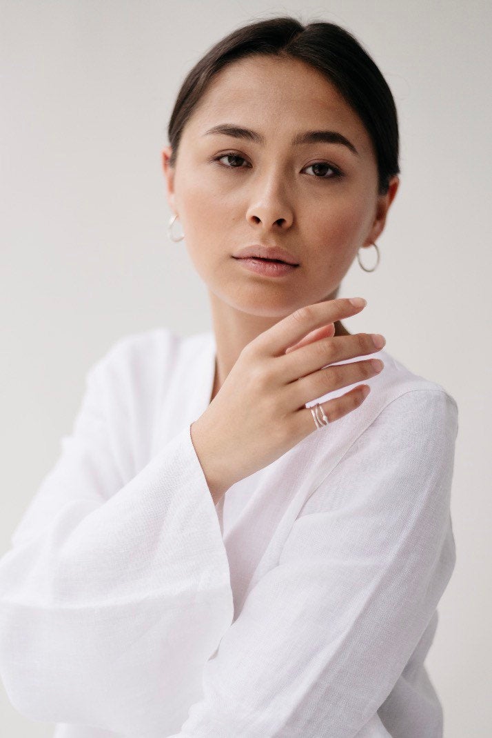 Portrait of model wearing Studio Adorn Silver bead stacking ring