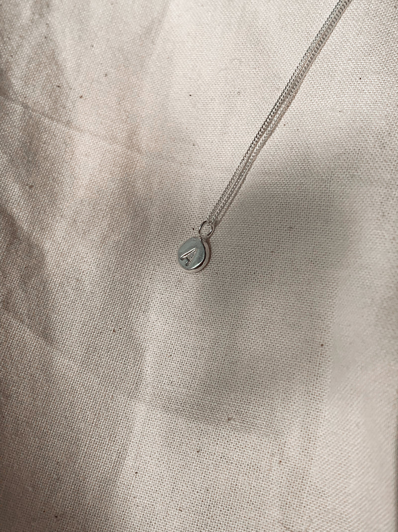 Sustainable and ethical silver pebble pendant necklace handmade by Studio Adorn