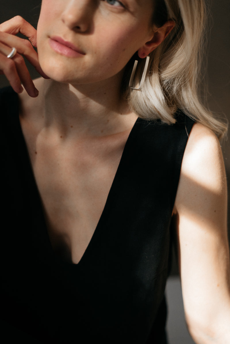 Model wearing statement rectangle chunky silver hoop earrings handmade by Studio Adorn