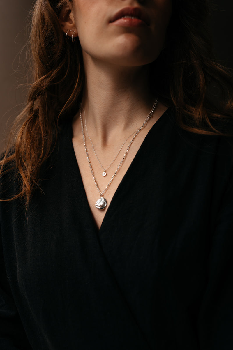 woman wearing layering necklaces in sterling silver