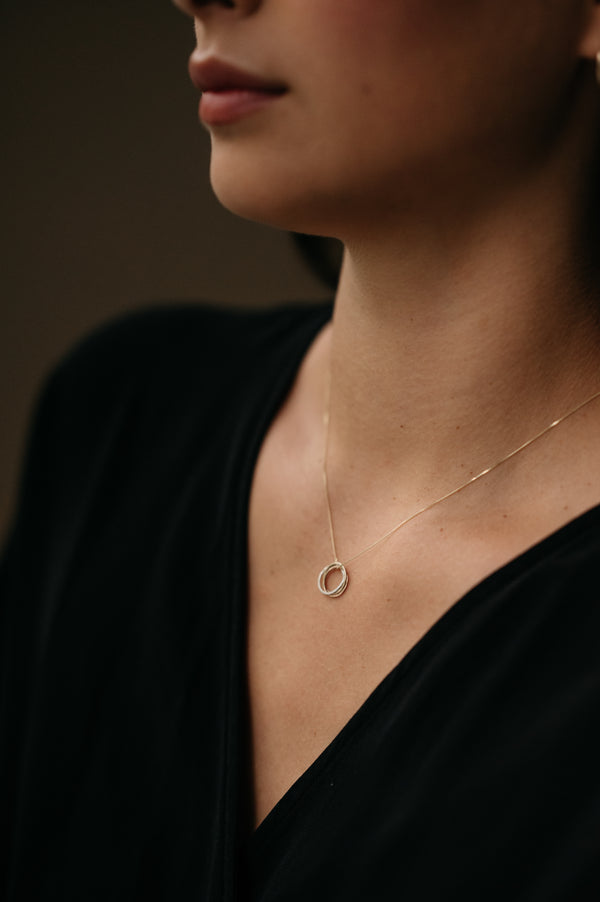 woman wearing a trio Of Metals Knot Pendant Necklace | Studio Adorn Jewellery UK