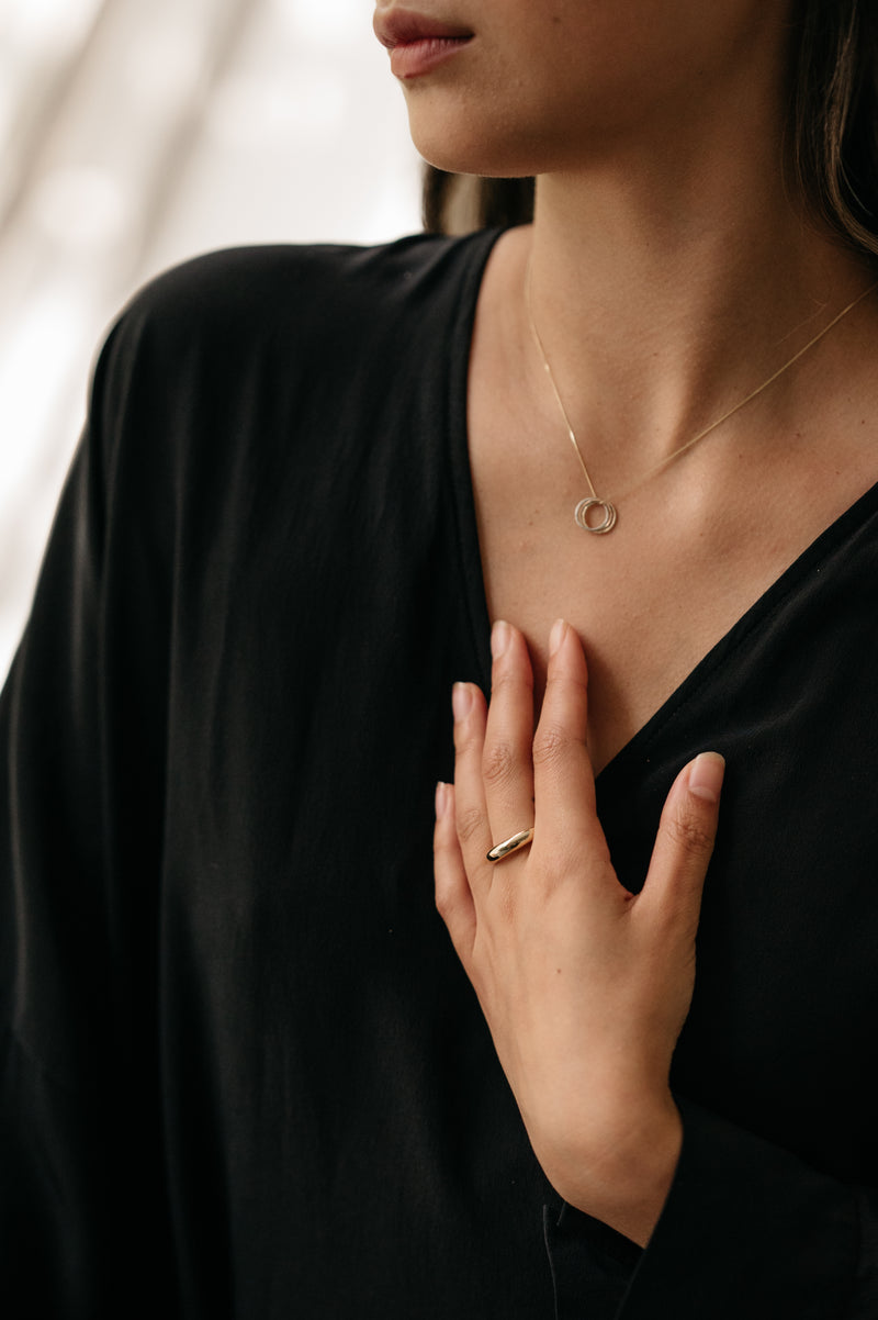 Model Wearing Trio Of Metals Knot Pendant Necklace | Studio Adorn Jewellery UK
