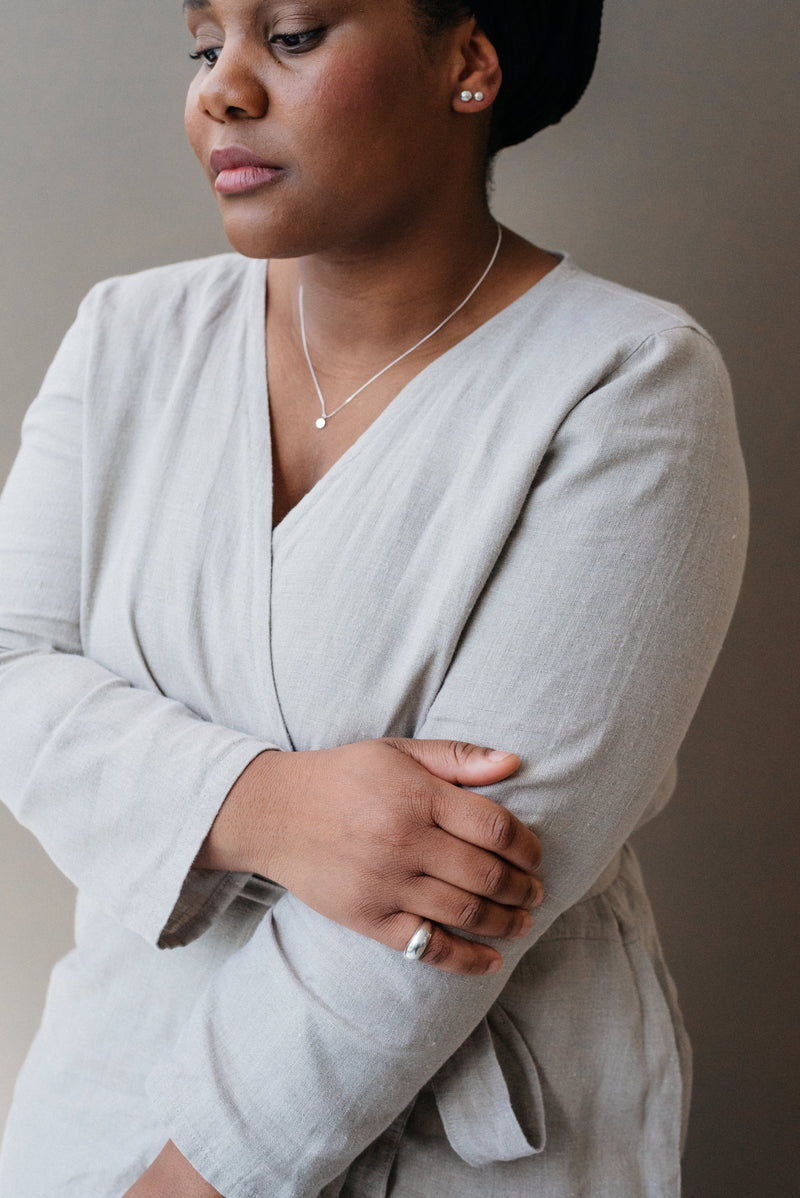 Model wearing Sustainable and ethical silver pebble pendant necklace handmade by Studio Adorn