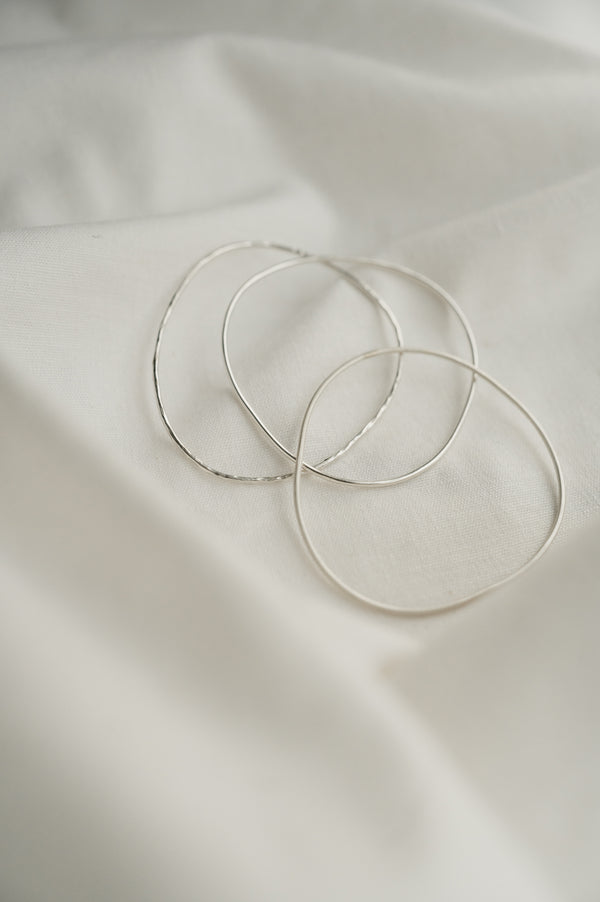 Organic Shaped Bangles made by Studio Adorn Jewellery from Recycled Silver